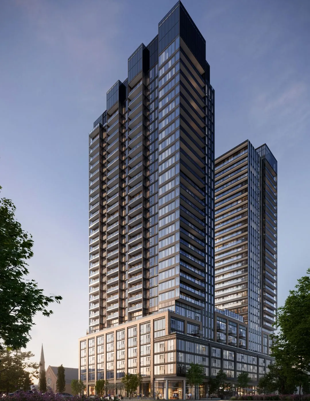 Rendering of the glass towers of The Design District rising above tree-lined Wilson Street at dusk